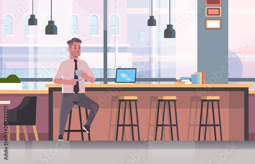 businessman sitting on chair at bar counter with laptop coffee break concept business man drinking cappuccino modern cafe interior flat full length horizontal