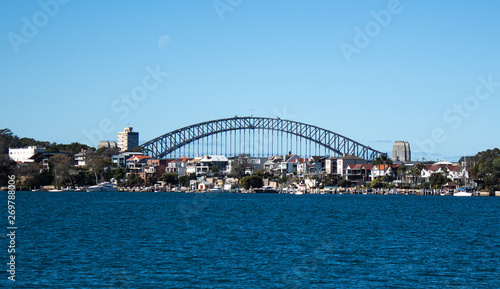 City Harbourside houses at Robinsons Point Birchgrove Sydney Australia with Harbour bridge in background against blue sky