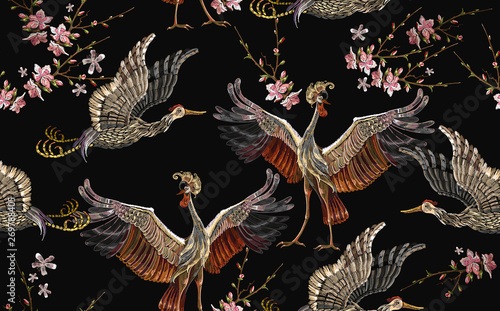 Embroidery crane birds and sakura flowers seamless pattern. Asian template for clothes, textiles, t-shirt design. Japanese art