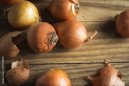 messy onions on wooden background