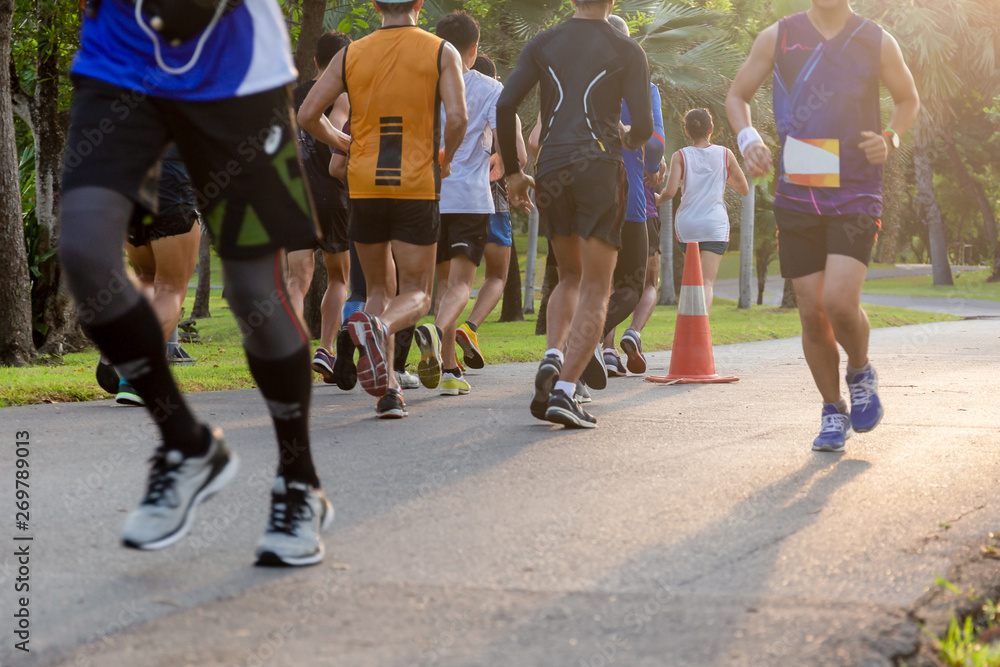 Fototapeta premium Selected focus group of marathon people jogging in the park in morning.
