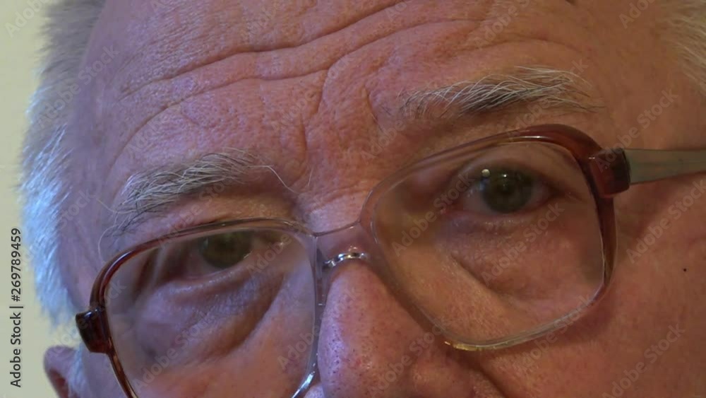 modern senior man with wrinkles brown eyes grey hair and eyebrows looks at camera and making selfie close view modern senior man with wrinkles brown eyes grey hair and eyebrows looks at camera and making selfie close view