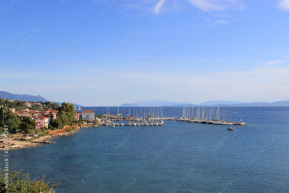 Harbor of Palairos town in Aitolakarnania in Greece at summer. Background view sailing boats moored and tied at the small marina