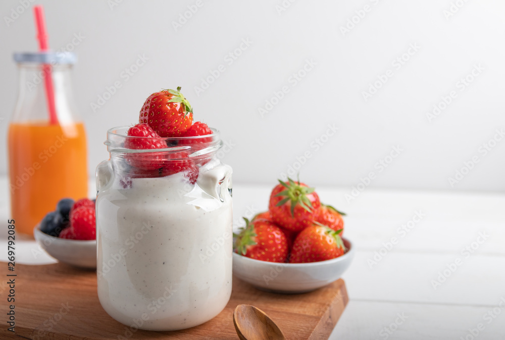 A serving of yogurt with fresh fruit on a breakfast table A serving of yogurt with fresh fruit on a breakfast table