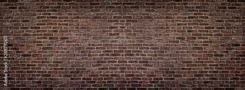 Wide red shabby brick wall texture. Old masonry panorama. Dark rough brickwork panoramic background