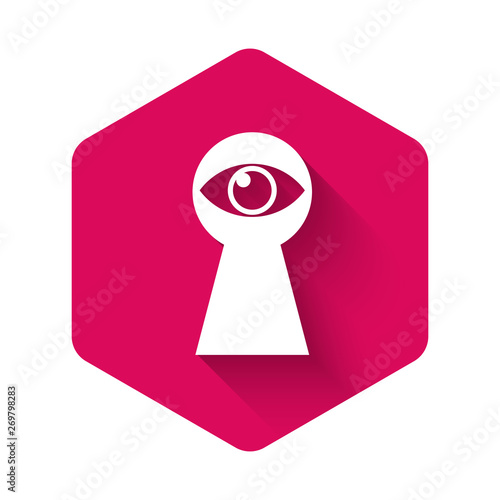 White Keyhole with eye icon isolated with long shadow. The eye looks into the keyhole. Keyhole eye hole. Pink hexagon button. Vector Illustration