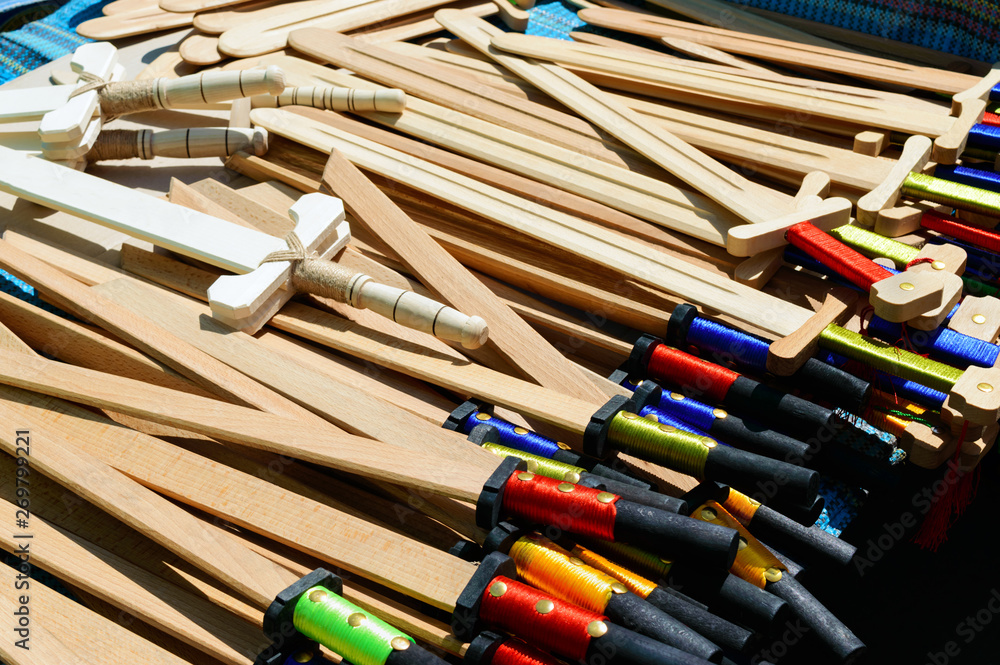 Wooden children's weapons - sabers, swords. Eco toys. Fair - an exhibition of folk craftsmen. Wooden children's weapons - sabers, swords. Eco toys. Fair - an exhibition of folk craftsmen.