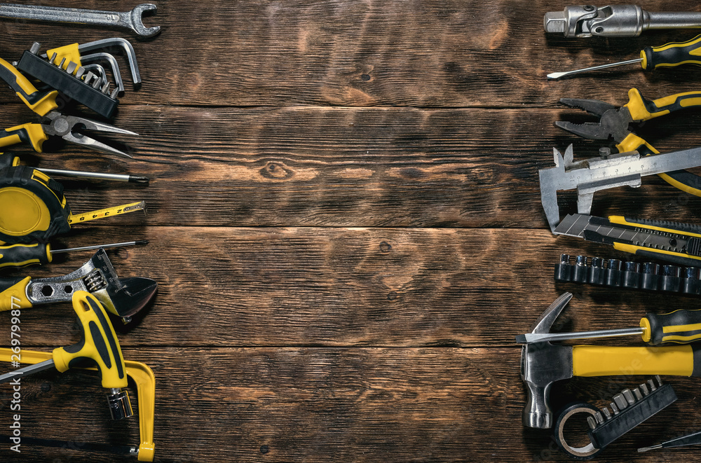 Construction flat lay background with copy space. Work tools on a wooden workbench.