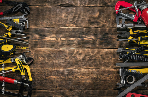 Construction flat lay background with copy space. Work tools on a wooden workbench.