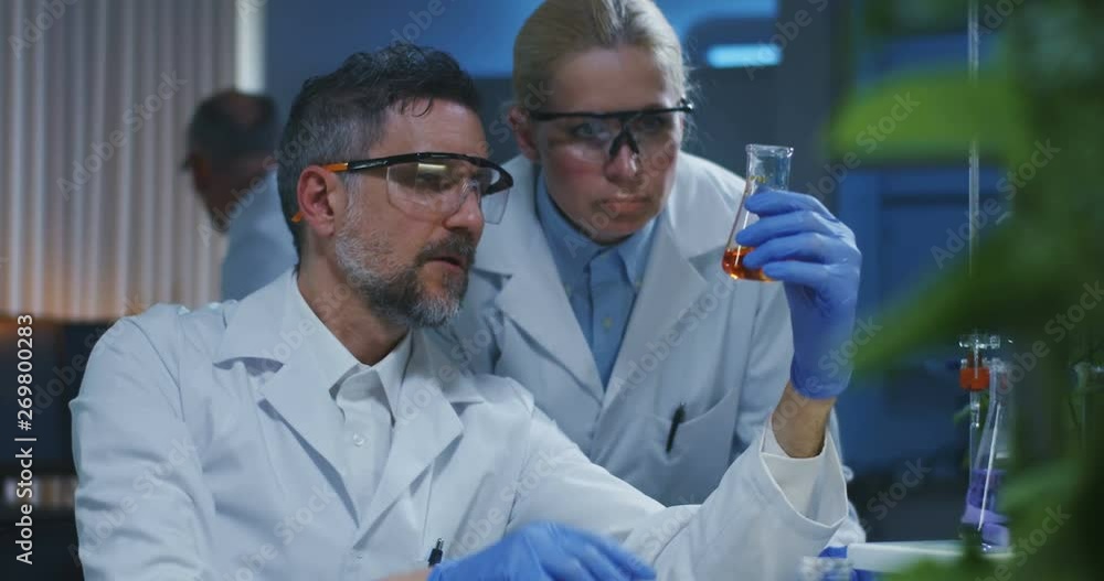 Scientists examining various liquids Scientists examining various liquids