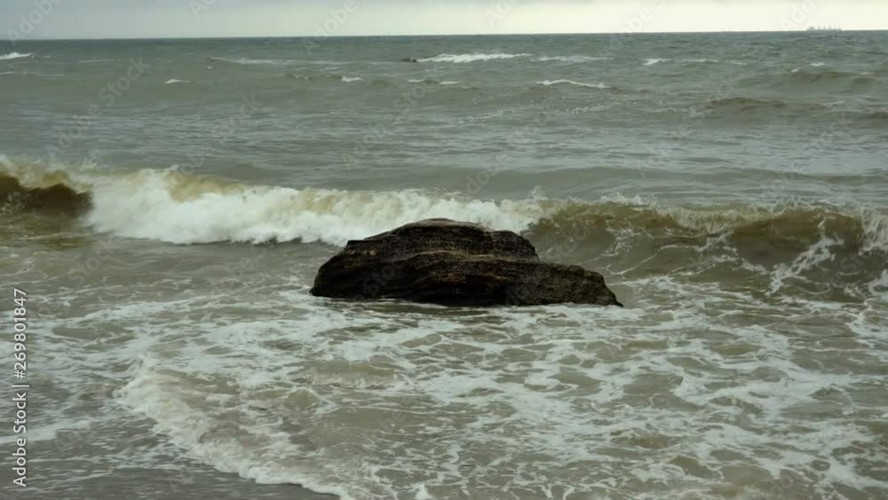 Surf at Black Sea. Small waves broken on coastal stones in Black sea near Odessa. Coastline, splashing, crashing, seafoam. Surf at Black Sea. Small waves broken on coastal stones in Black sea near Odessa. Coastline, splashing, crashing, seafoam.