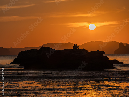 Silhuate couple with romantic sunset time photo