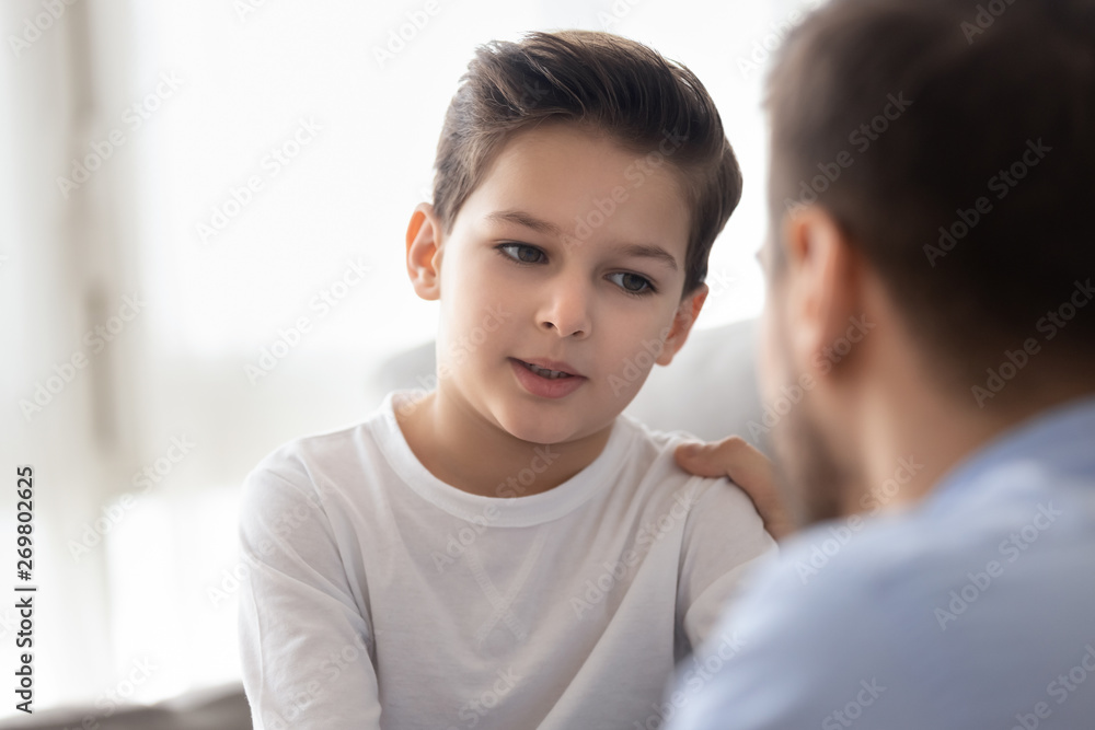 Caring dad talk with little son showing love and support Caring dad talk with little son showing love and support