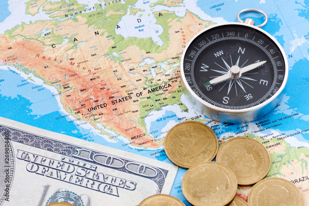 Financial Concept : US Dollar Coin and Compass on America Map Background.