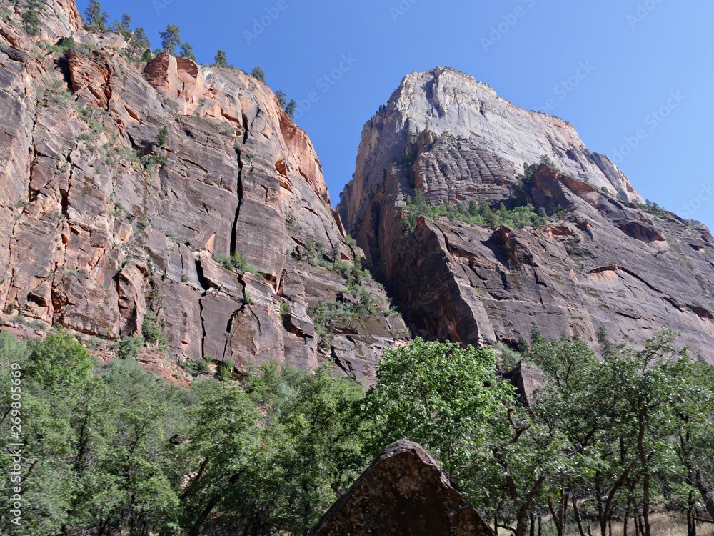 Breathtaking shot of imposing rocks and steep sandstone cliffs at Zion National Park, Utah. Breathtaking shot of imposing rocks and steep sandstone cliffs at Zion National Park, Utah.