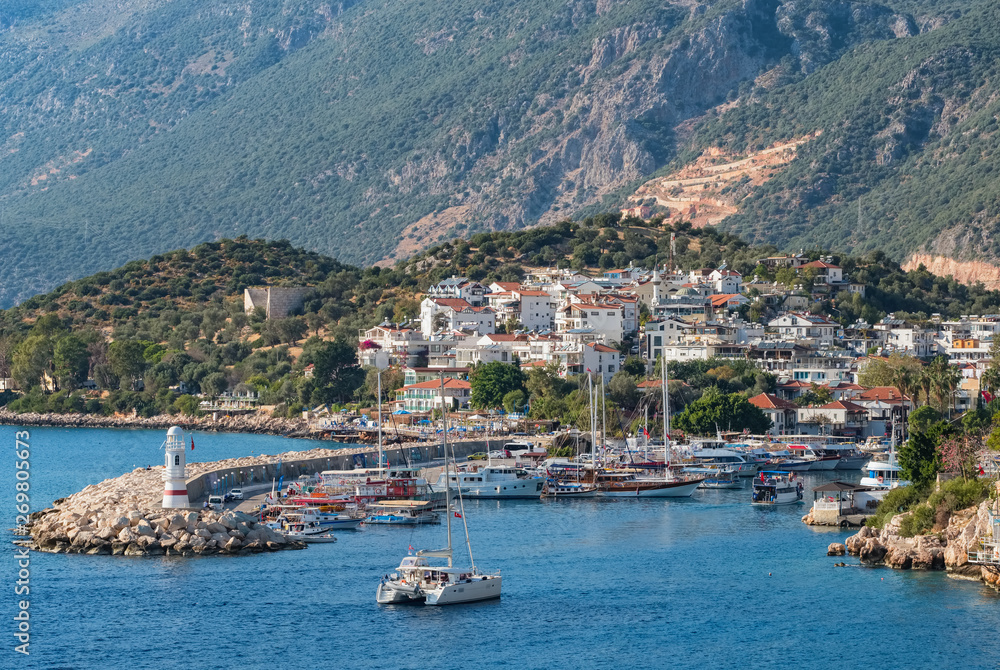 Fototapeta premium Kas lighthouse and harbour at daytime, Turkey
