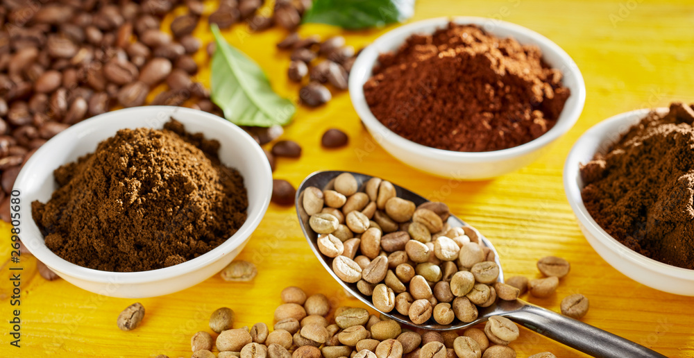 Raw white coffee beans with freshly ground coffee Raw white coffee beans with freshly ground coffee
