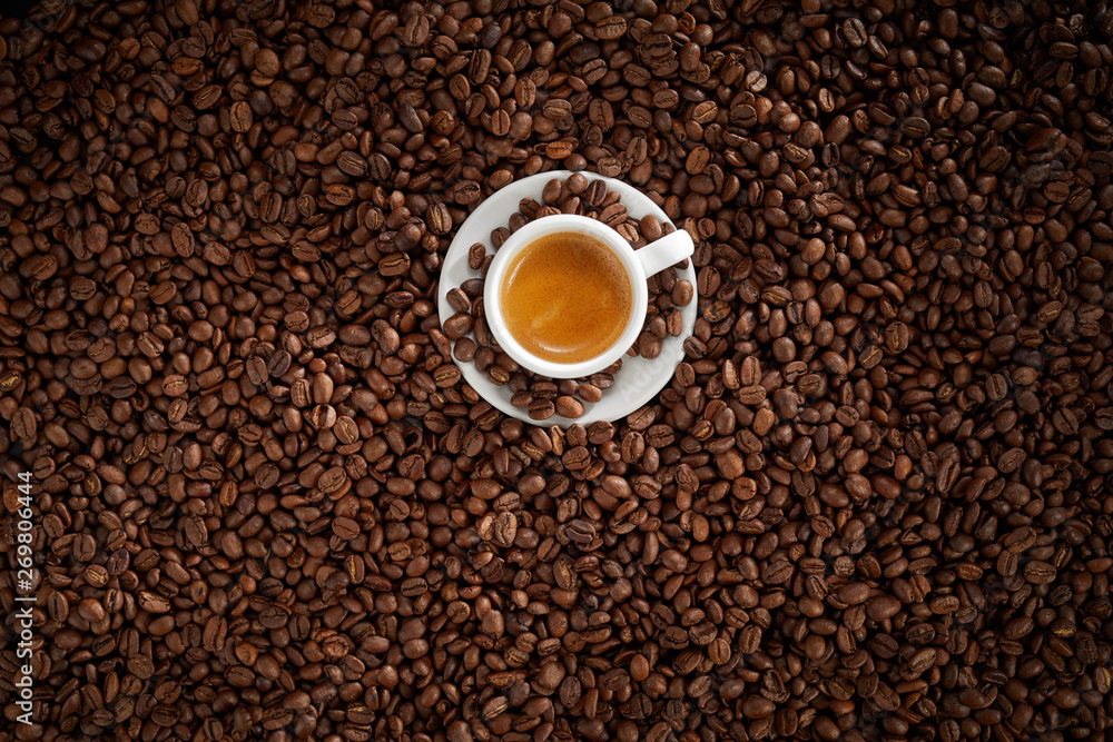 Small white cup of frothy strong espresso coffee Small white cup of frothy strong espresso coffee