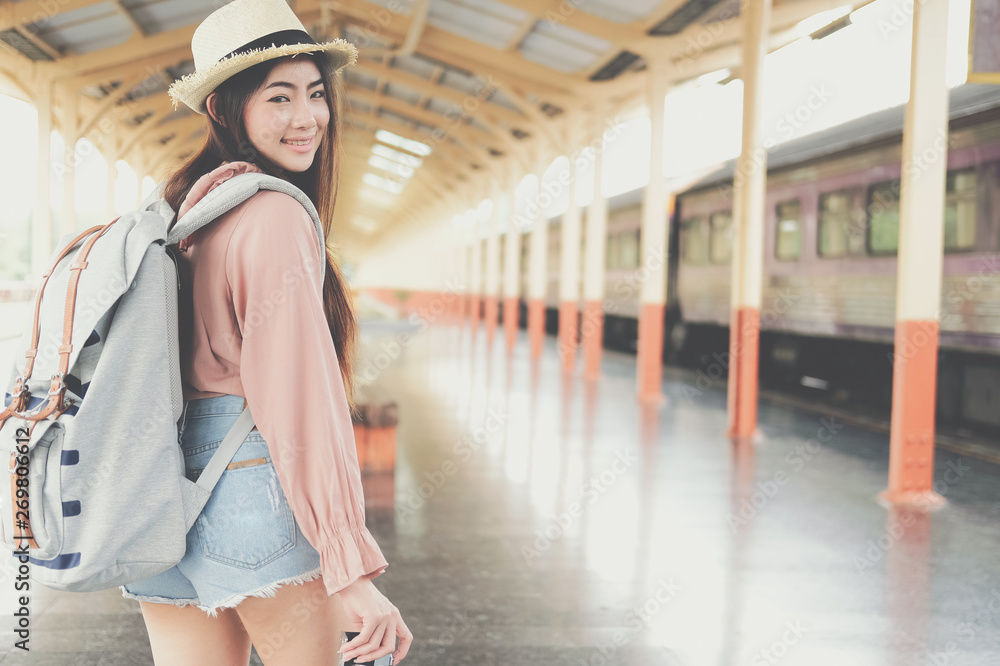 woman  backpacker traveler with camera backpack at train station. journey trip travel concept