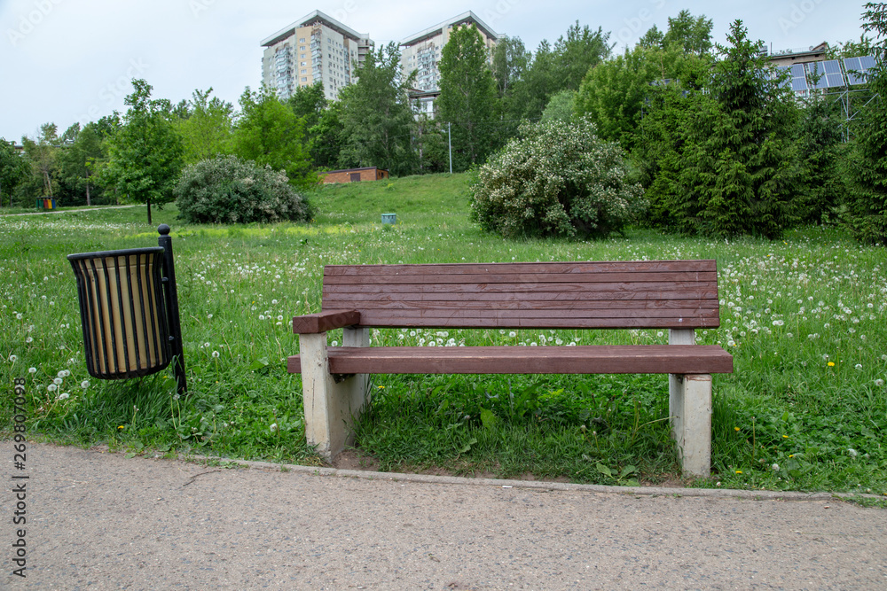 Wooden bench with a urn in the park. Wooden bench with a urn in the park.