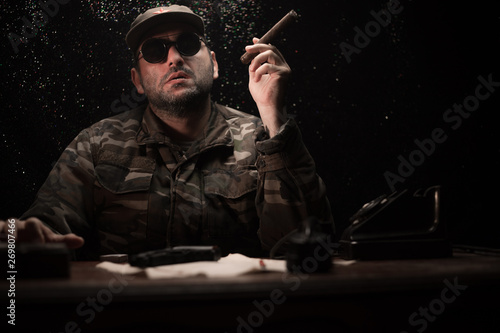 Canvas Print The evil dictator sitting on table