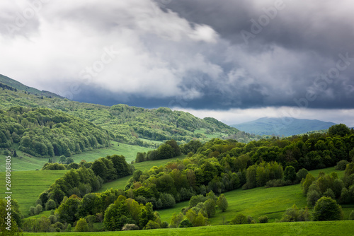 Fototapeta Naklejka Na Ścianę i Meble - Stormy weather with dramatic rainy clouds over green peaks in Carpathian Mountains, Bieszczady,Poland