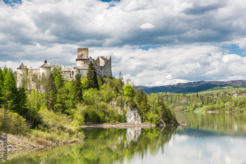 Niedzica castle on cliff at Czorsztyn lake in Poland. Green landscape overview