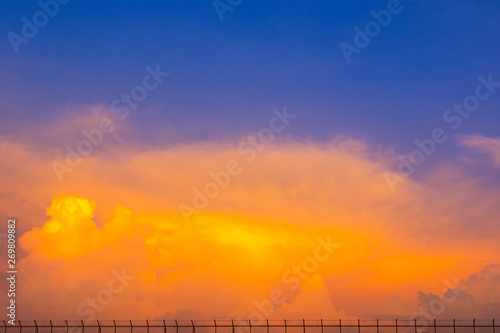 orange and blue sky with small fence on base of picture and the image can use for commercial background.