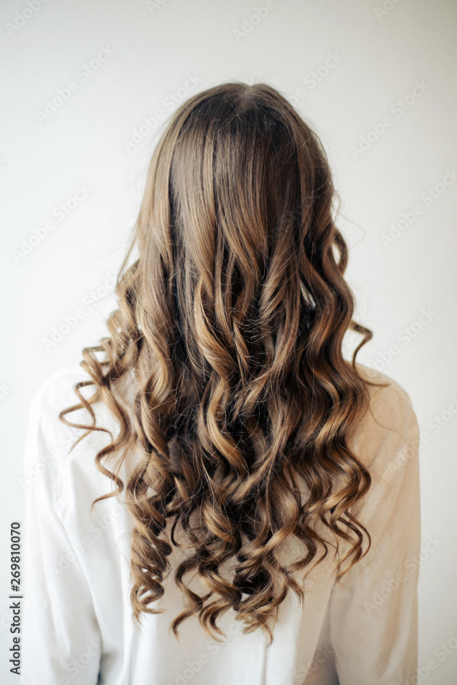 Closeup of female hands of hairdresser or coiffeur makes hairstyle Closeup of female hands of hairdresser or coiffeur makes hairstyle