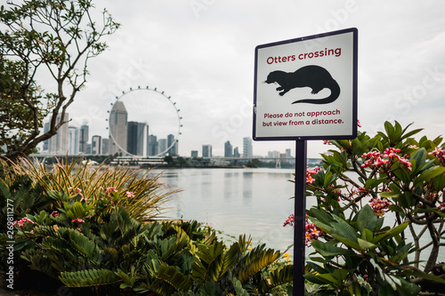 Photography Singapore: Otter crossing sign in front of the river, view on downtown with Mari