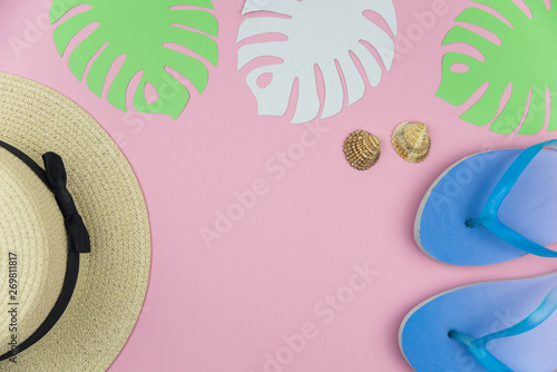 Flat lay traveler accessories on trendy pink background with straw hat, palm leaf, airplane, sea shells and sunglasses. Top view travel and planning summer vacation concept. 