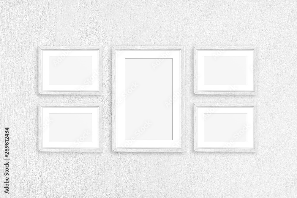 Frames collage, five white painted wooden realistic frameworks isolated on white plastered wall Frames collage, five white painted wooden realistic frameworks isolated on white plastered wall