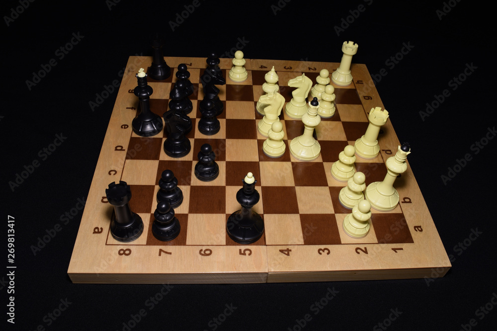 Wooden chess board under black pieces as a skill concept Wooden chess board under black pieces as a skill concept