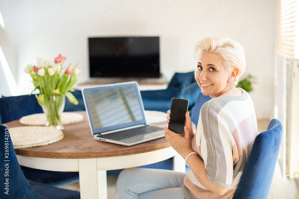 Attractive age woman working in home office. Attractive age woman working in home office.