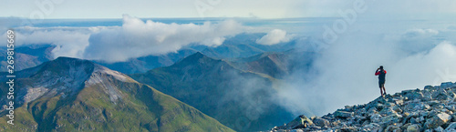 Man and Mountains on Top of Ben Nevis, Scotland photo
