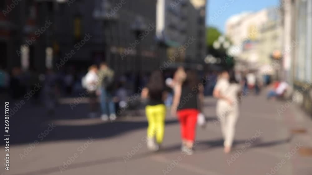 Blurred crowd of tourists people walking along the street of the old city Blurred crowd of tourists people walking along the street of the old city