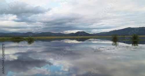 Flying low and fast over the Cerknisko lake in Slovenia with amazing reflections 4K