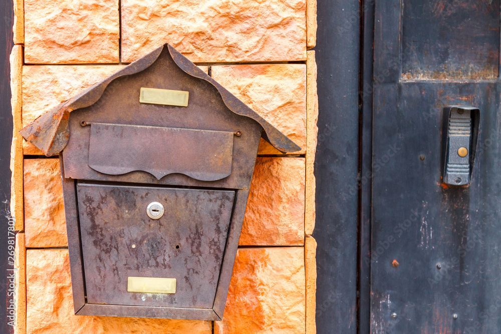 A beautiful mailbox hangs waiting for newspapers, parcels and letters.