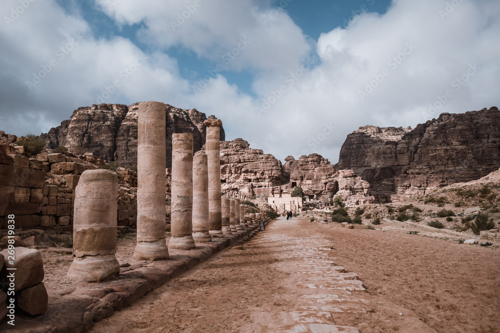 Temple columns and ruins in desert landscape of Petra, Jordan, Asia