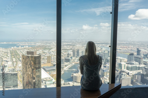 Girl on window with Melbourne skyline © Florian