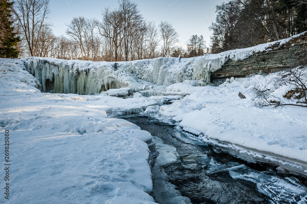  Famous waterfall in Estonia. Keila-Joa Schloss Fall. Partly frozen waterfall by winter. Estonia.