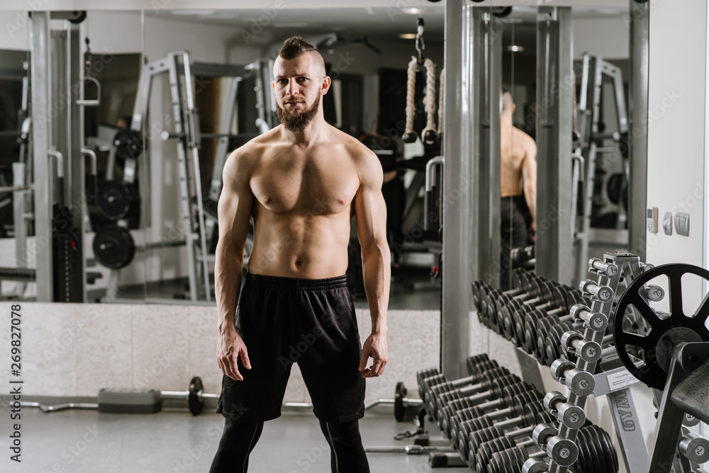 Fototapeta premium Strong muscular man ready for exercises in the gym