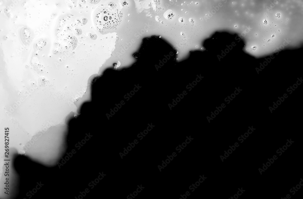 Spilled milk puddle isolated on black background and texture with clipping path, top view Spilled milk puddle isolated on black background and texture with clipping path, top view