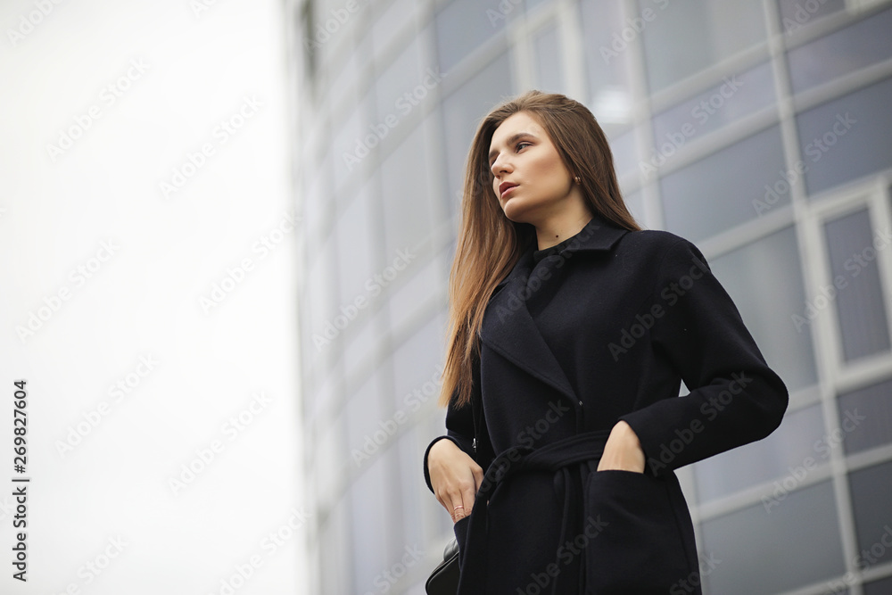Beautiful girl in a coat in business downtown Beautiful girl in a coat in business downtown