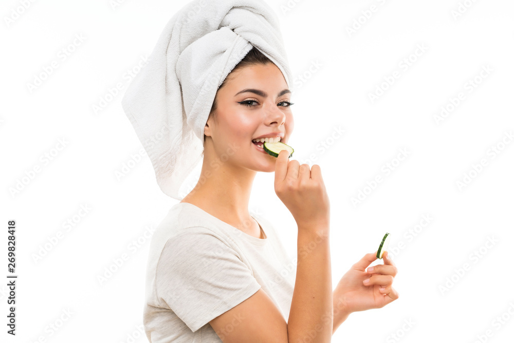 Beautiful young woman holding slices of cucumber. Beautiful young woman holding slices of cucumber.