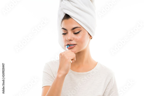 Teenager girl over isolated white background brushing her teeths