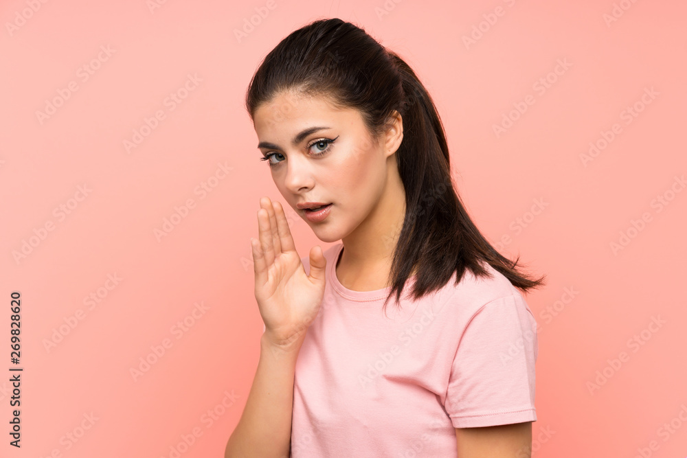 Teenager girl over isolated pink background whispering something Teenager girl over isolated pink background whispering something