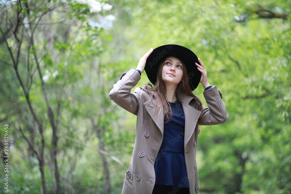 Young girl in a coat in a spring park Young girl in a coat in a spring park