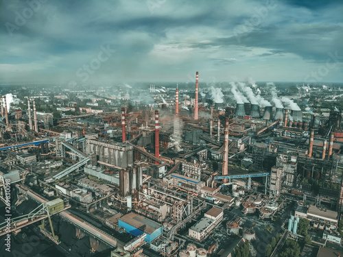 Industrial zone landscape aerial view with smoke from metallurgical factory or plant chimneys. Air and environment pollution, global warming