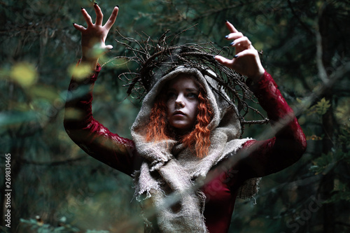 The red-haired witch holds a ritual with a crystal ball